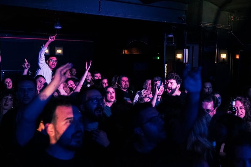 The crowd at Sax! club with their hands in the air